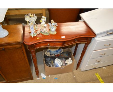 A hardwood serpentine hall table fitted two drawers