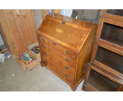 A reproduction yew wood bureau fitted four long drawers 