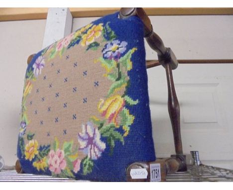 A good quality footstool with tapestry seat.