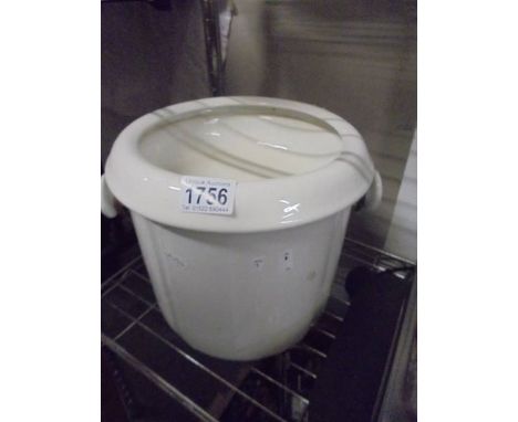 A ceramic slop bucket.