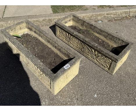 A pair of weathered planter troughs