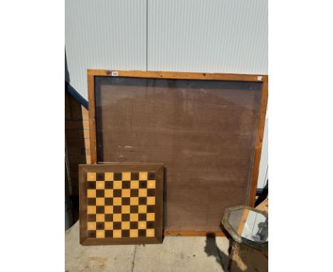 A glass cabinet and wooden chess board