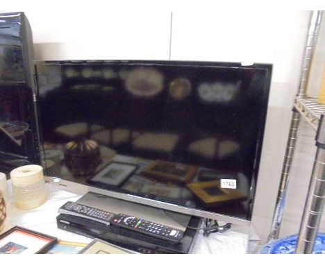 A flat screen television and a Samsung DVD player with remotes.