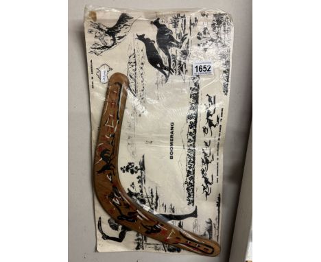 An aboriginal decorated boomerang in original bag