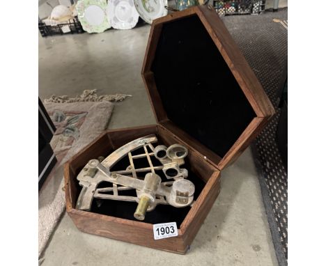 A brass sextant in teak box