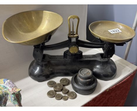 A set of cast iron kitchen scales with weights