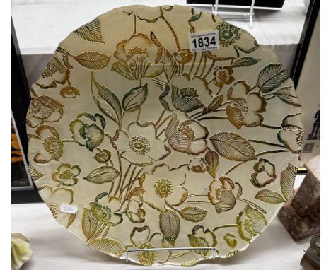 A large reverse painted glass charger