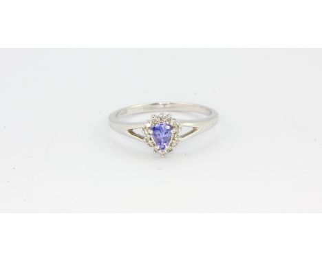 A 9ct white gold pear cut tanzanite and diamond set cluster ring, (O).