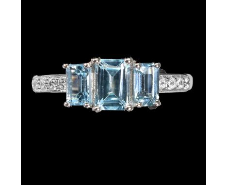 A 925 silver ring set with three emerald cut blue topaz and white stone set shoulders.