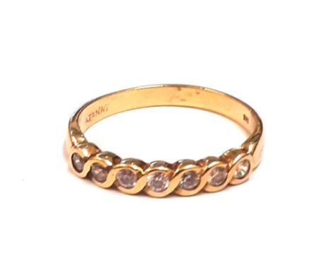 A 14ct yellow gold diamond set half eternity ring, (O).