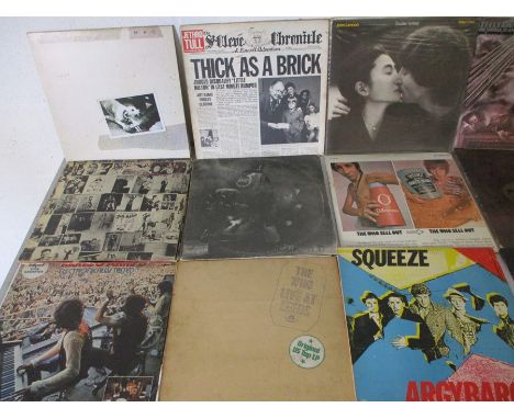 A collection of 12" vinyl records including The Rolling Stones, Fleetwood Mac, Jethro Tull, Free, Steely Dan, Genesis, James 