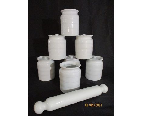 A collection of 7 vintage storage jars ( 1 no lid) along with a pottery rolling pin