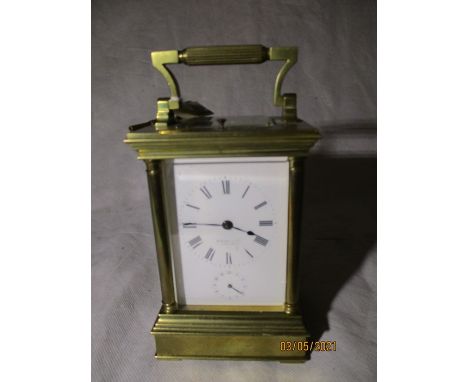 A large brass carriage clock with alarm and repeater. The white enamel dial signed H Moser Et Cie, St Petersburg (slightly ru