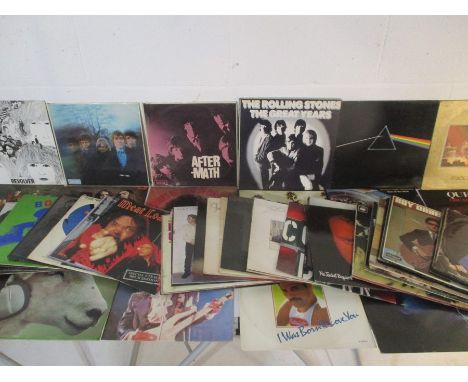 A collection of 12" vinyl records including The Beatles, Rolling Stones, The Eagles, Alexis Korner's, Pink Floyd, Deep Purple