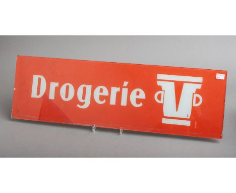 Werbeschild "Drogerie" (50/60er J.), Glas, weiß/orange, m. Logo, Gr. ca. 78 x 24 cm.