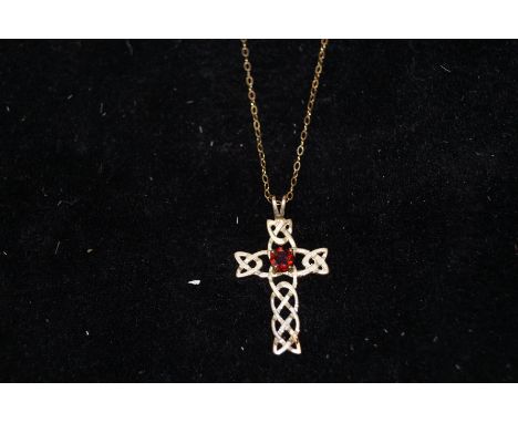 Yellow metal (tested for gold) chain and Celtic cross pendant with central red stone