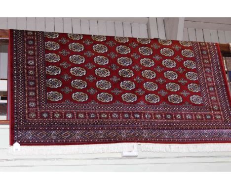 Bokhara carpet with a red ground 3.00 by 2.00.