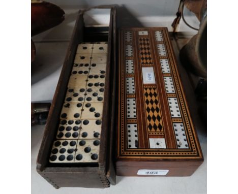 An inlaid cribbage board with dominoes and a set of double nine dominoes 