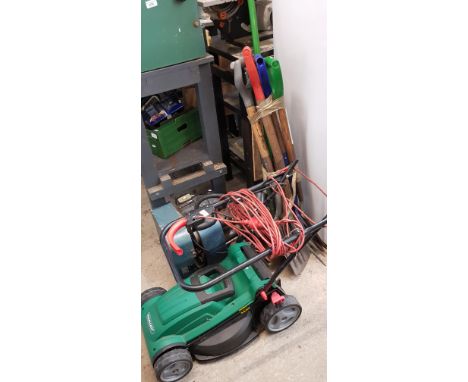 A Qualcast rotary lawn mower together a bundle of garden tools 