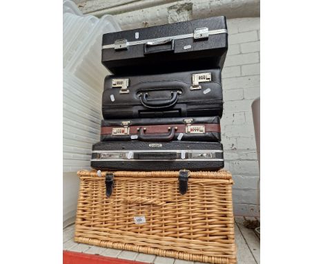 Four vintage cases and a wicker picnic basket. 