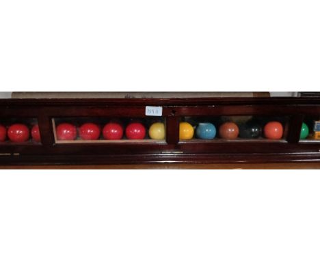 An early 20th century snooker ball cabinet including a full set of full size Super Crystalate snooker balls, together with a 