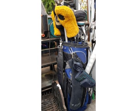 A bag of assorted golf clubs to include Wilson iron set, Hippo hybrid, Cobra driver, balls, tees &amp; a trolley etc.