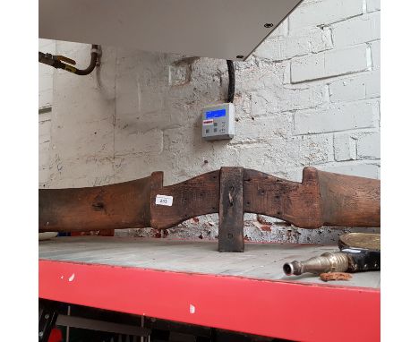 A vintage wooden yoke with metal hooks. 