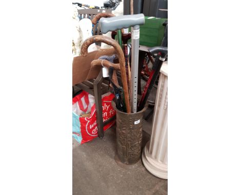 A Brass Umbrella stand complete with walking sticks 