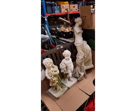 Three garden ornaments on plinths together with a wall hanging garden ornament and a jardiniere stand 