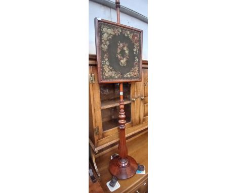 A 19th century mahogany tapestry pole screen.