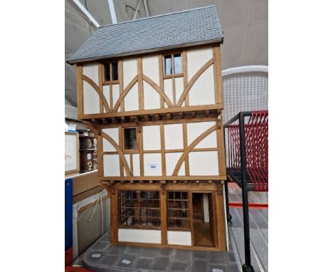 A model tavern/dolls house with electric lighting and furniture.Dimensions:- Approx. 46cm x 40cm x 82cm height.