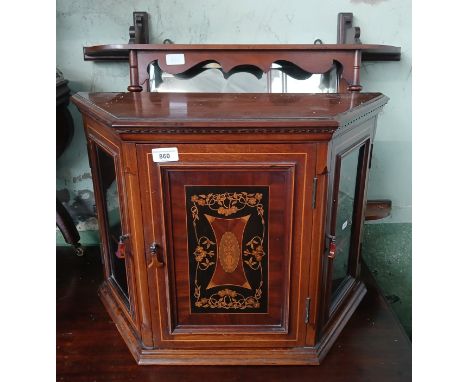 An Edwardian marquetry inlaid cabinet and a mirrored wall shelf. 