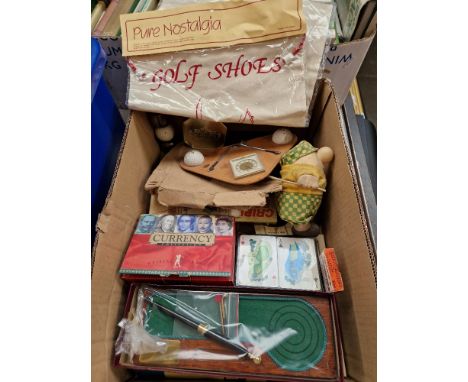 A box of golfing related collectables including novelty desk stand, clock, silver plated liquor measure, Currency collection 