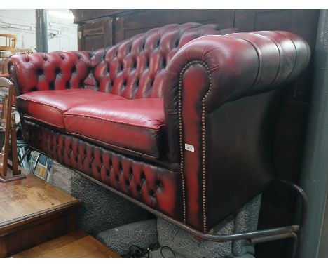 An oxblood buttoned leather Chesterfield settee. 