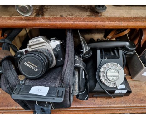 A Canon EOS 50E 35mm camera with case, together with a black bakelite phone