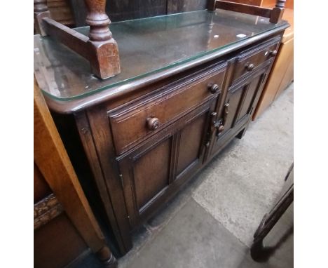 An Ercol Priory style cabinet. 