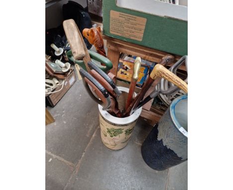A pottery stick stand and contents.