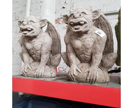 A pair of concrete gargoyle garden ornaments 