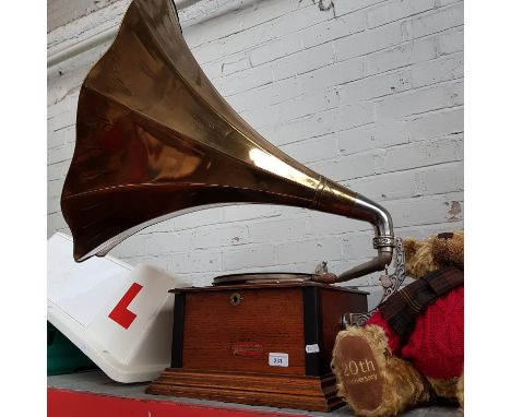 A Junophone oak cased gramophone with brass trumpet. 