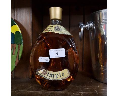 A bottle of Dimple old blendid scotch whisky 
