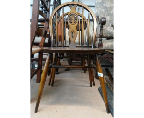 Two Ercol 'Fleur de Lys' chairs and a mahogany nest of tables. 