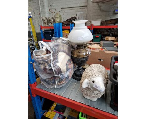 A ceramic sheep, 2 paraffin table lamps, and a bed topper