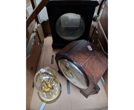 A Georgian bracket clock case, an art deco mantle clock and a revolving pendulum clock.