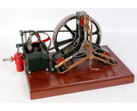 A fine scratch built pumping engine having twin opposed cylinders in V formation at 120°, large 7" spoked flywheel with belt 