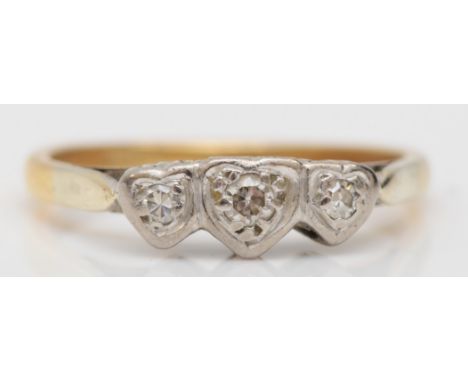 An 18ct gold three stone brilliant cut diamond dress ring, with heart shaped settings, K, 2.1gm. 