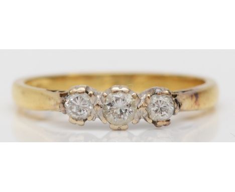 An 18ct gold three stone brilliant cut diamond dress ring, stated weight .25 total, M, 2.5gm. 