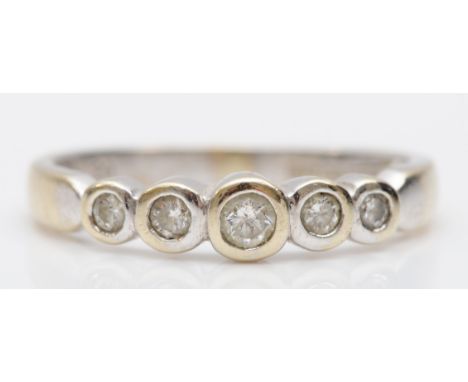 A 9ct white gold five stone brilliant cut diamond ring, stated weight .20, M, 1.9gm. 