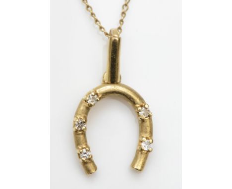 A 375 gold brilliant cut diamond horseshoe pendant, 20mm, on a unmarked gold chain, 1.5gm. 