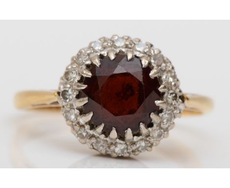 An 18ct gold garnet and eight cut diamond cluster ring, K-L, 3.2gm. 