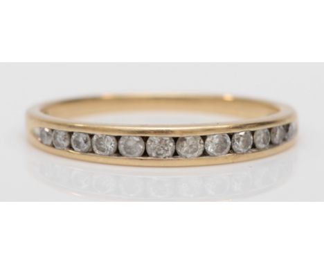 A 9ct gold channel set brilliant cut diamond dress ring, stated weight .25, L-M, 1.2gm. 